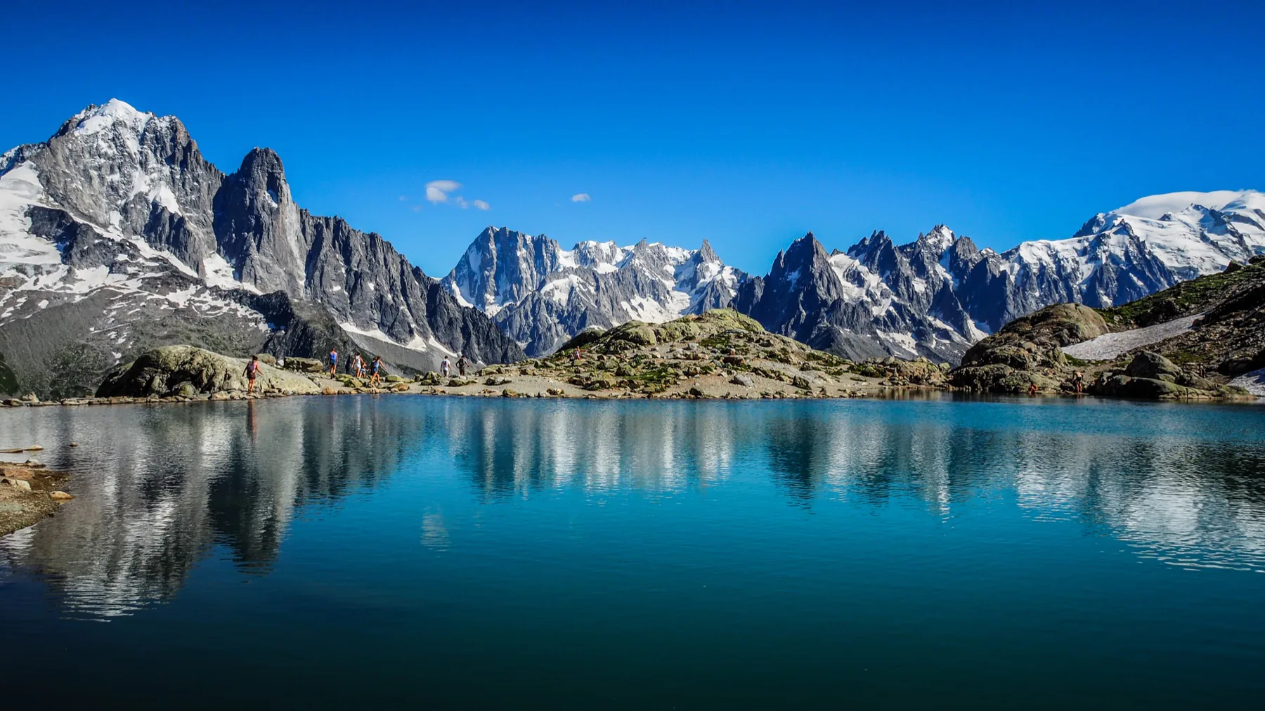 Snow-capped mountains reflected in a clear alpine lake