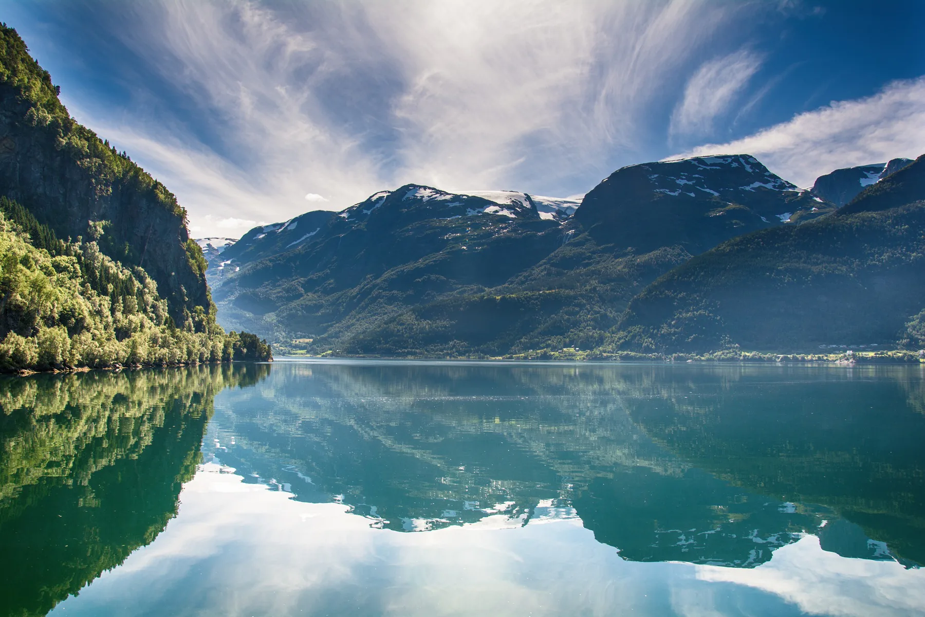 A Norwegian fjord surrounded by steep mountains and tranquil water