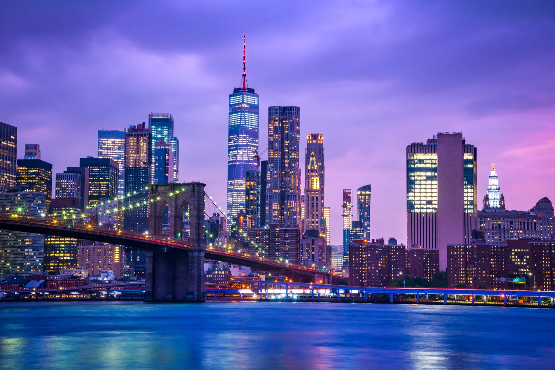 Brooklyn Bridge and the Manhattan skyline illuminated at dusk